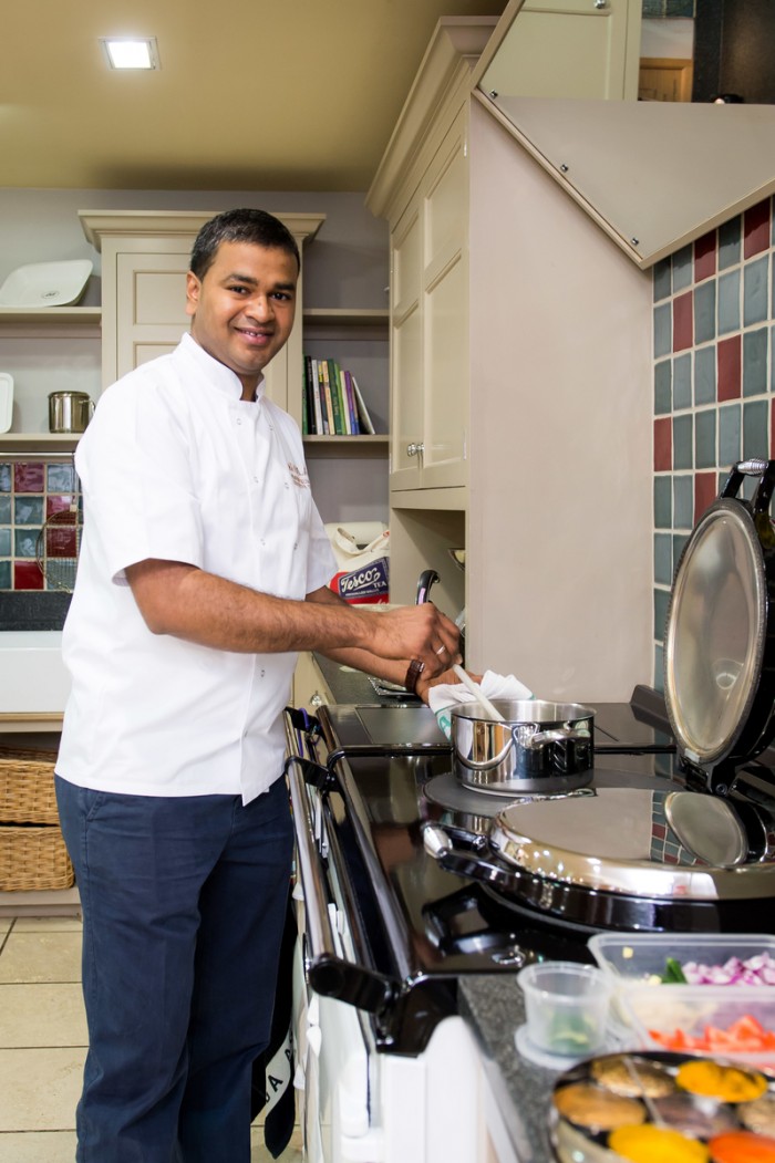 Praveen Kumar pulls on his cook demo apron and prepares to show us how the great British Classic handles his Indian Cuisine.