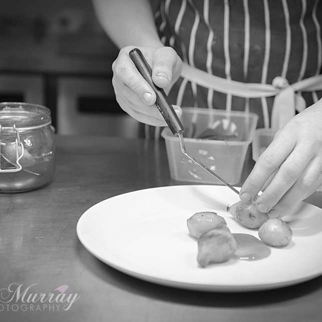 Andrew setting the jerusalem artichokes onto his plate.