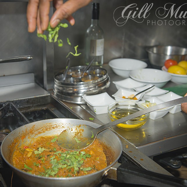 Praveen adds the herbs that make all the difference to flavour.