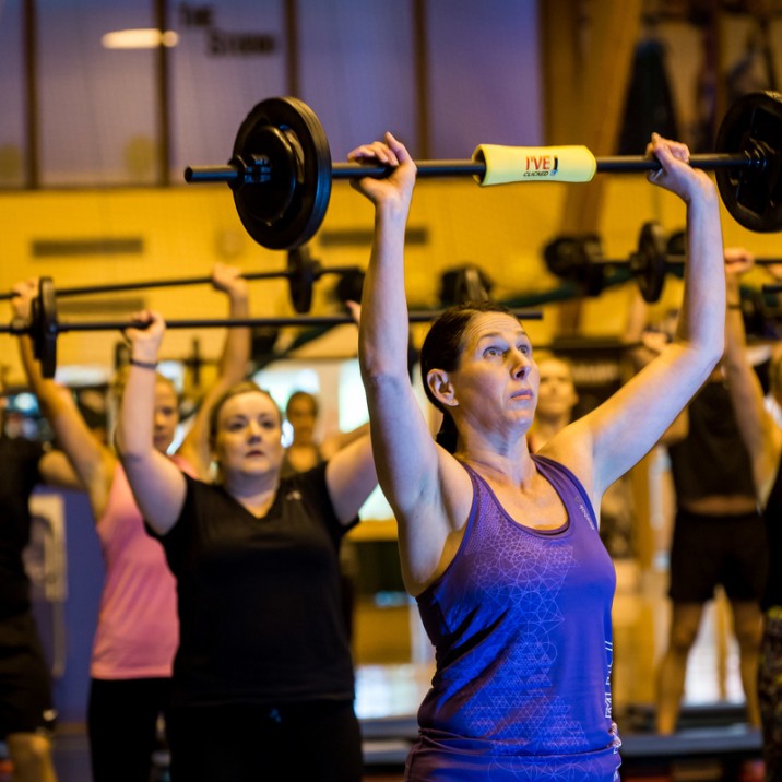 Andrea Thom, a LAL Body Attack Instructor lifting weights for GRIT!
