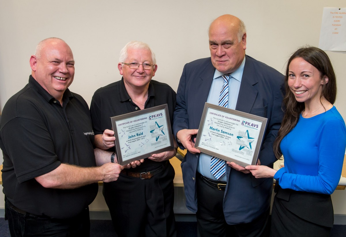 Shopmobility volunteers receiving award for 10 years of service.