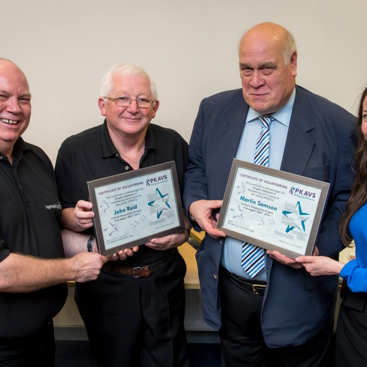 Shopmobility volunteers receiving award for 10 years of service.