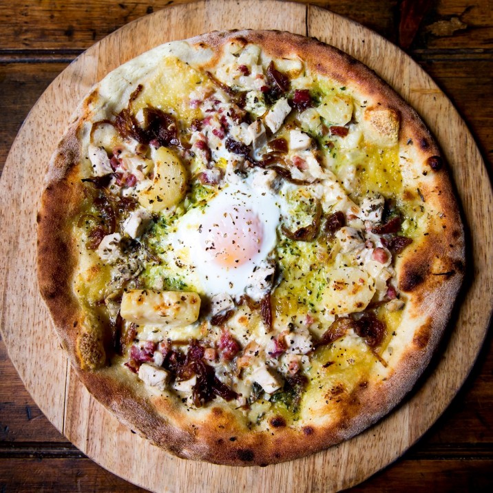 Pizza Paysanne: Creme Fraiche, Gruyere, Chicken, Caramelized Onions, Lardons, Potatoes, Garlic Butter, Egg.