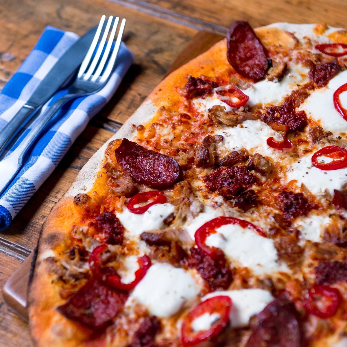 Pizza Posh Picante: Tomato, Mozzarella, Pulled Pork, N'Duja Sausage, Calabrese SausageRoquito Chillies, Mascarpone