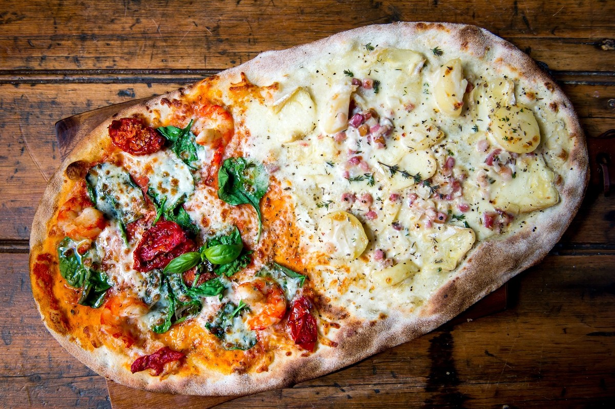 Pizza Mare and Montagne: 1/2 Tomato Mozzarella, Fresh Spinach, Hot Smoked Salmon, King Prawns, Sunblushed Tomato AND 1/2 Creme Fraiche, Potatoes, Bacon, Onions, Reblochon