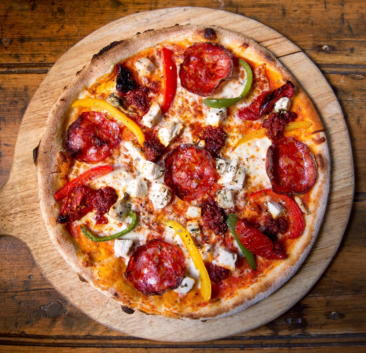 Pizza Mediterranean: Tomato, Mozzarella, Chicken, Spicy Chorizo, Peppers, Sunblushed Tomatoes, N'Duja Sausage