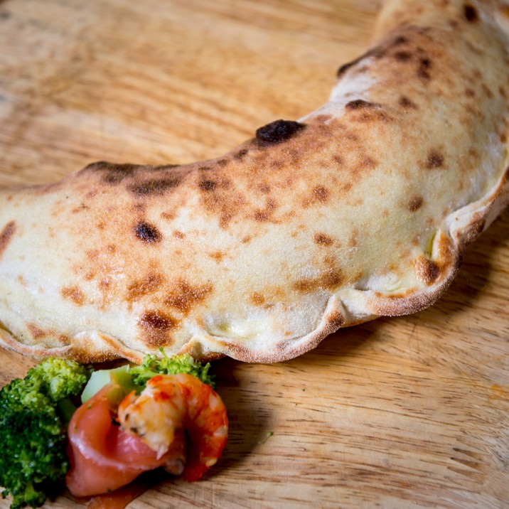 Pizza Calzone: Available in Calzone Di Mare with tomato,mozzarella, broccoli, hot smoked salmon and prawns OR in Calzone Animale with Chicken, Pancetta, Pepperoni, peppers, Tomato and Mozzarella.