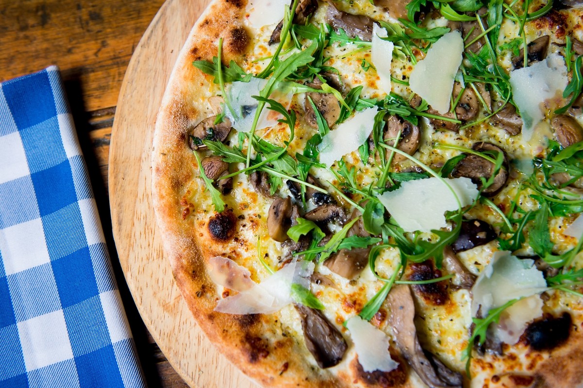 Pizza Funghi: Wild Mushrooms, Garlic Butter, Mozzarella finished with rocket, truffle oil and parmesan shavings