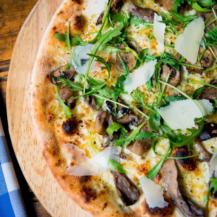Pizza Funghi: Wild Mushrooms, Garlic Butter, Mozzarella finished with rocket, truffle oil and parmesan shavings