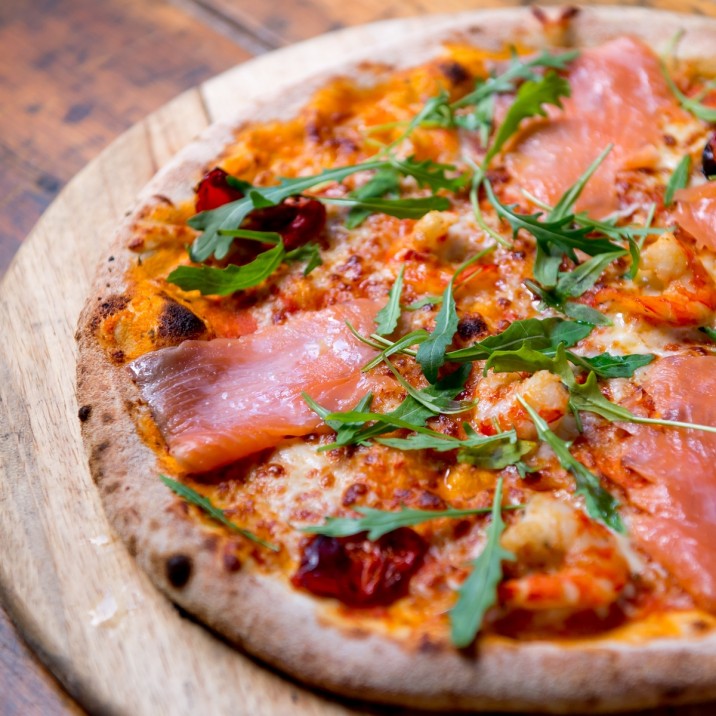 Pizza Mare: Tomato, Mozzarella, Hot Smoked Salmon, King Prawns, Sunblushed Tomato finished with rocket and a drizzle of lemon.