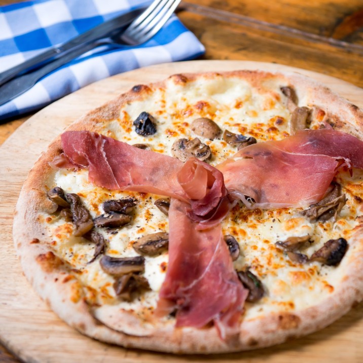 Pizza Roxanne: Wild Mushrooms, Goat Cheese, Creme Fraiche, Mozzarella and finished with Prosciutto