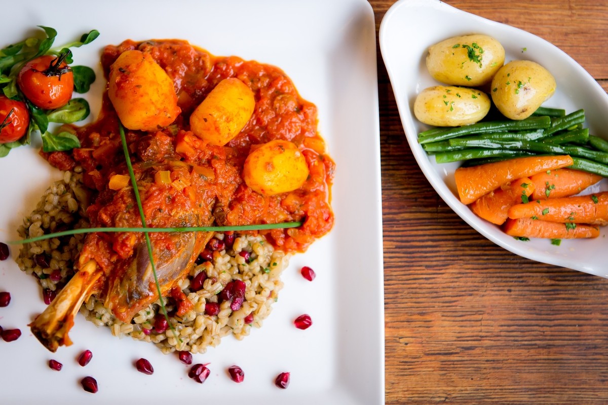 Scotch Lamb Tagine - Chefs Signature Dish Leg of Scotch lamb, braised in a Moroccan style tagine sauce,served with pearl barley and pomegranate risotto.