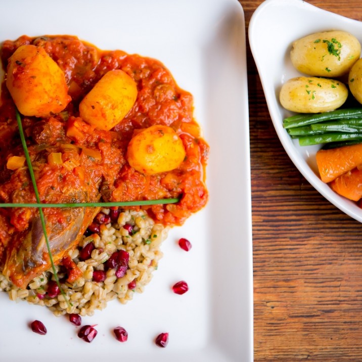 Scotch Lamb Tagine - Chefs Signature Dish Leg of Scotch lamb, braised in a Moroccan style tagine sauce,served with pearl barley and pomegranate risotto.