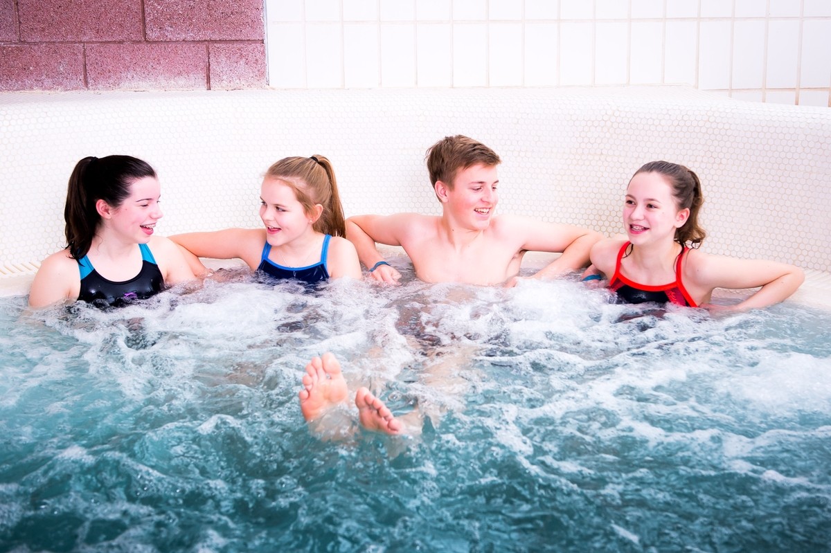 Teenagers having a gossip in the huge Jacuzzi bath at the Leisure Pool.