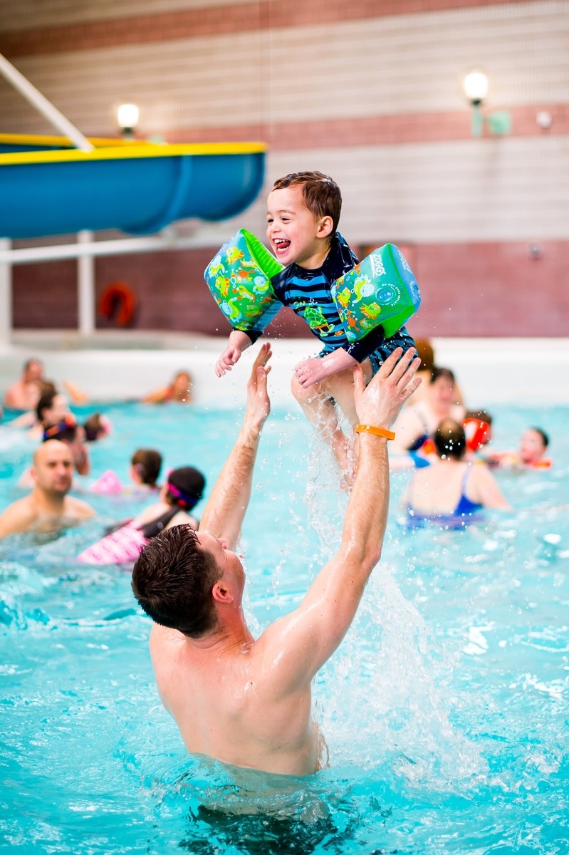 Dad and son having a great time in the pool.