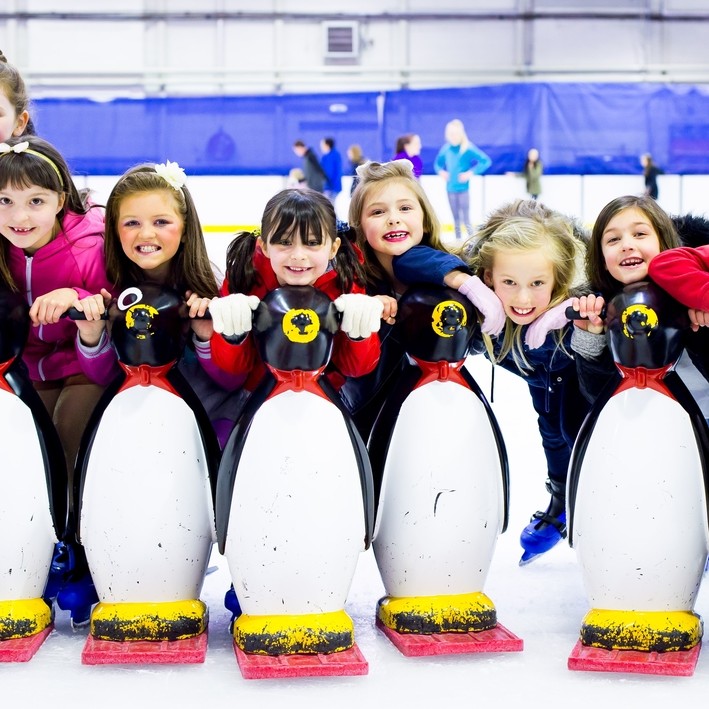 Kids having fun on the ice with the Penguin skate helpers!