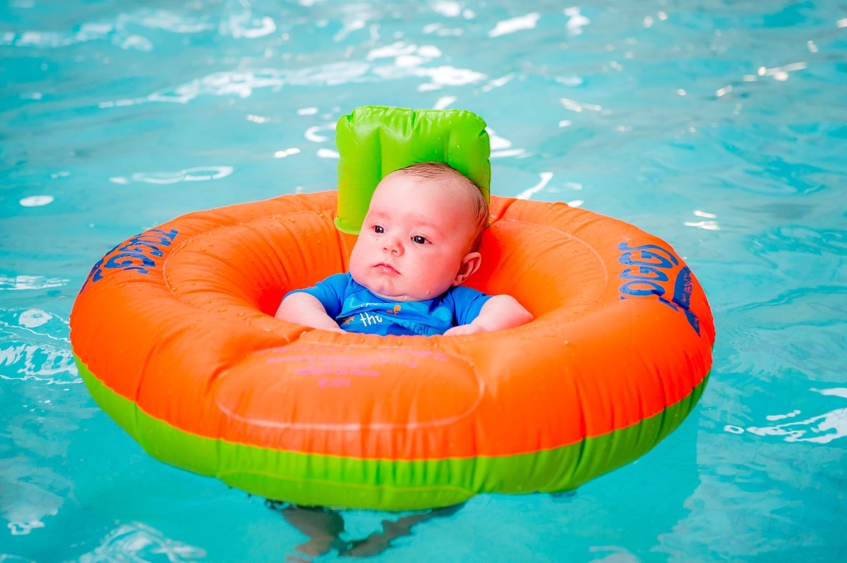 Baby in inflatable ring in the pool.