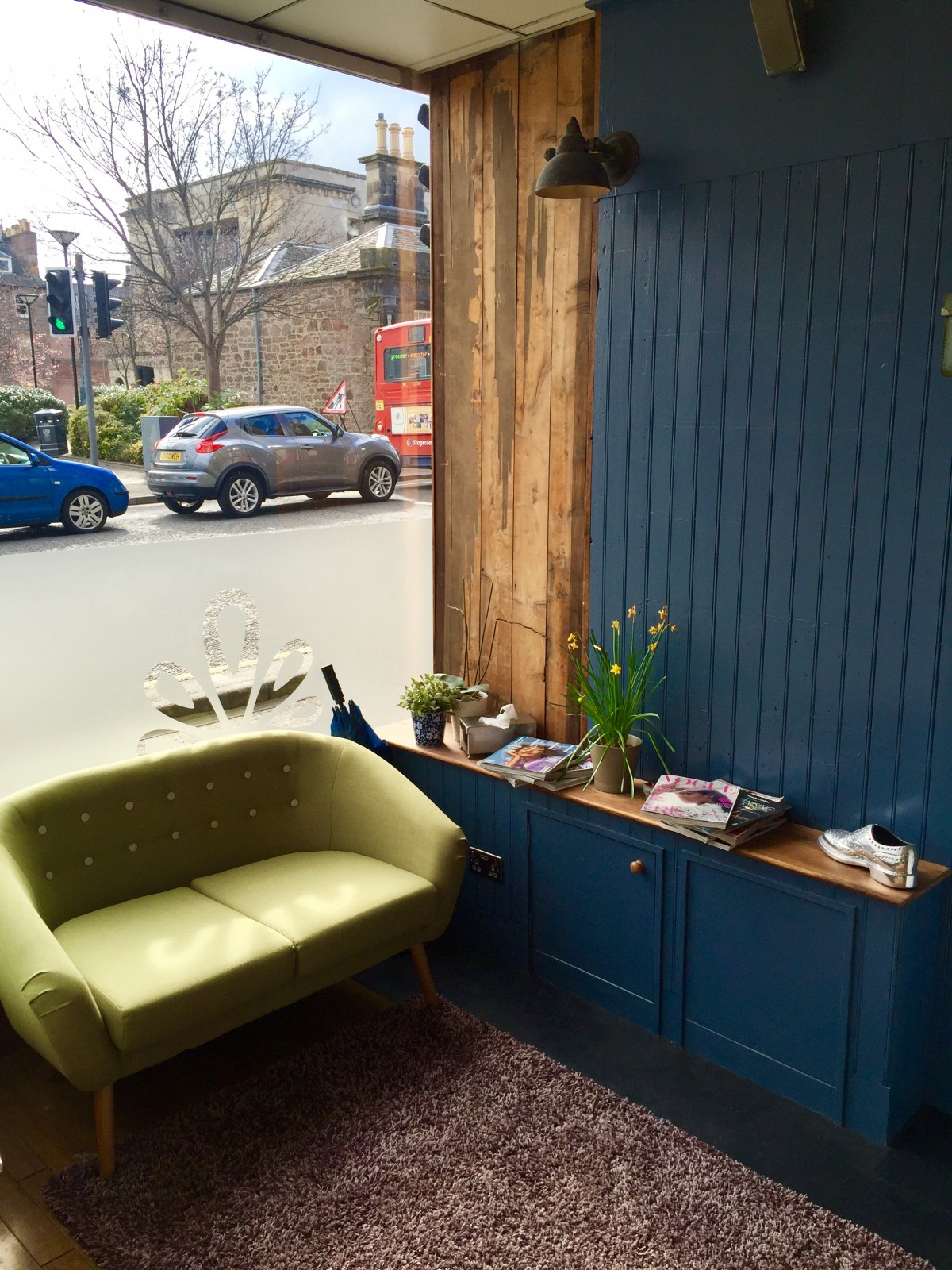 The vibrant lime green couch sits perfectly next to the navy wooden walls in the front lounge of the new Rae Peacock Hair Salon. We can definitely see ourselves sitting here with a brownie and a cocktail, perusing over the latest fashion mags!