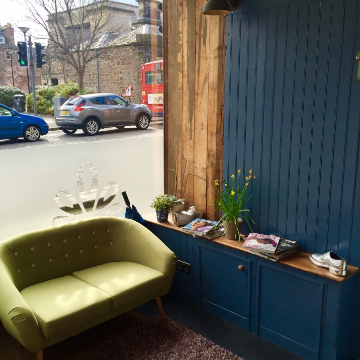 The vibrant lime green couch sits perfectly next to the navy wooden walls in the front lounge of the new Rae Peacock Hair Salon. We can definitely see ourselves sitting here with a brownie and a cocktail, perusing over the latest fashion mags!