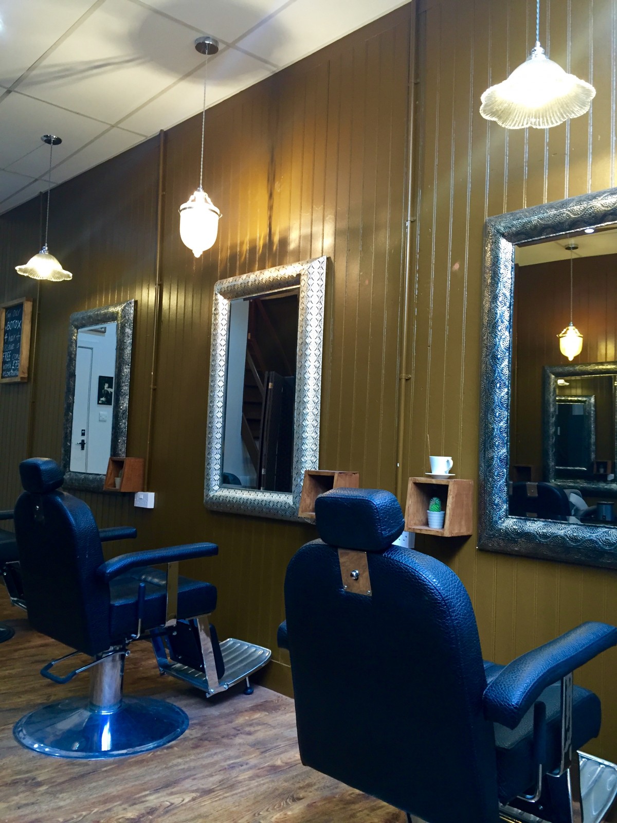 Deep leather chairs and cool mirrors in the Rae Peacock Hair Salon.