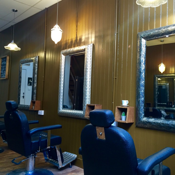 Deep leather chairs and cool mirrors in the Rae Peacock Hair Salon.