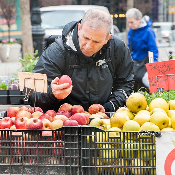 Somebody sampling the juicy, fresh apples from market stall in New York.