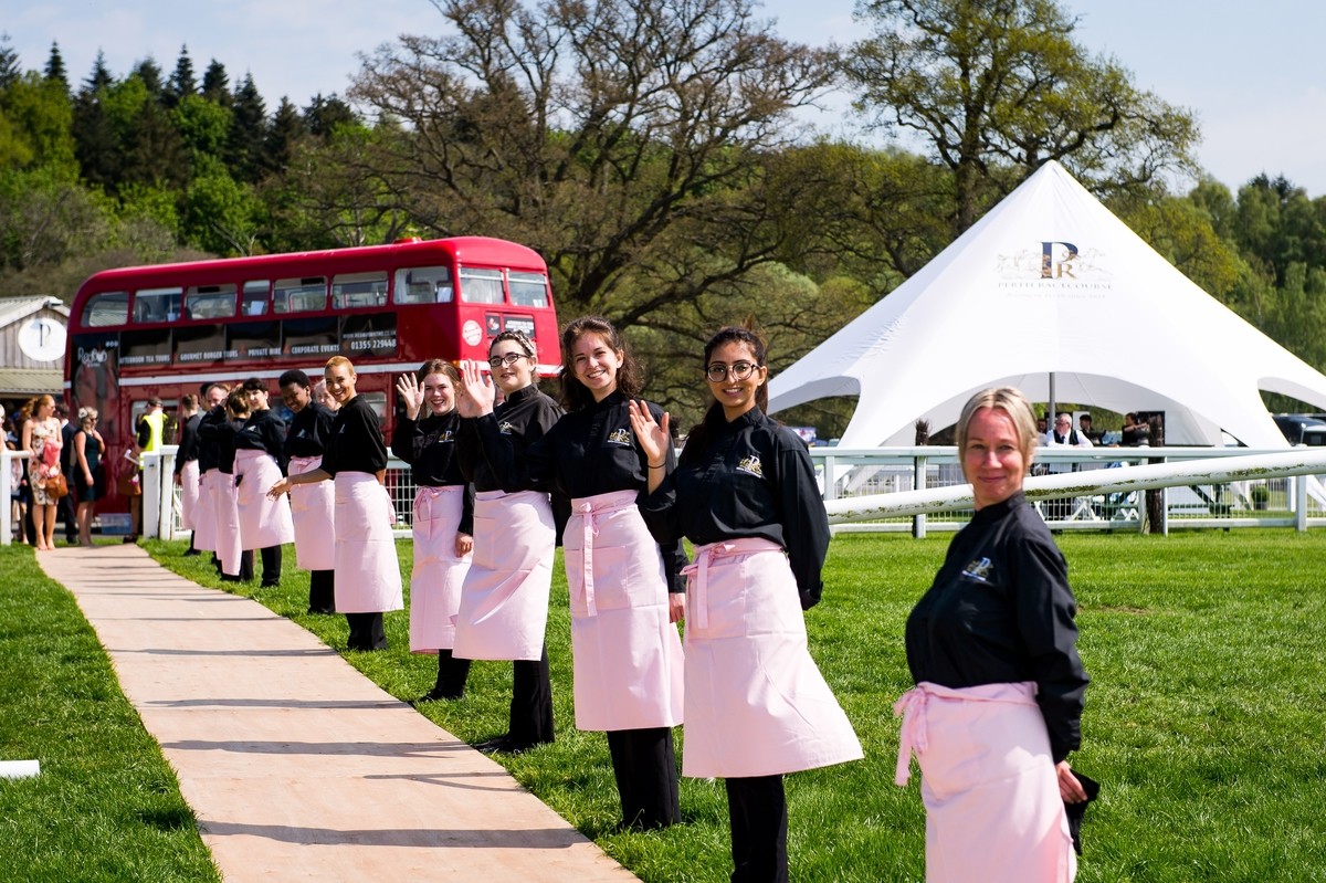 The smiling staff greeted the ladies coming into the event.  We loved the pink aprons!