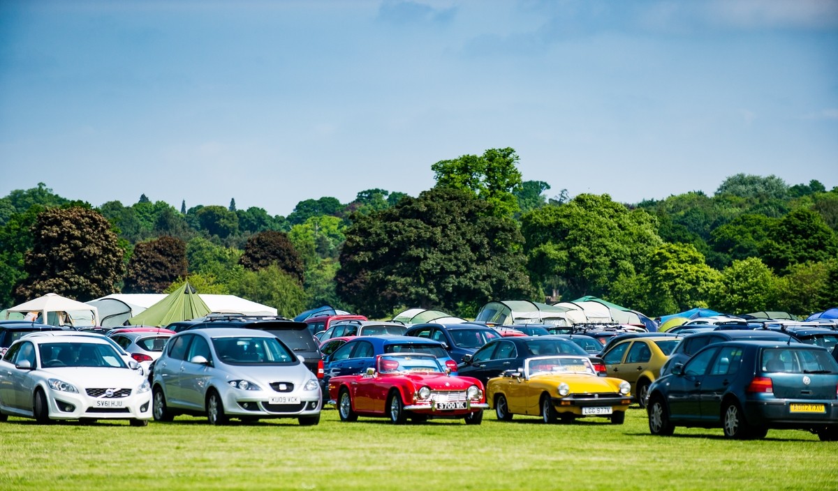 The cars in the car park for the Scottish Volleyball Championships at Perth in the North Inch, UK.  Those two classic cars look super!