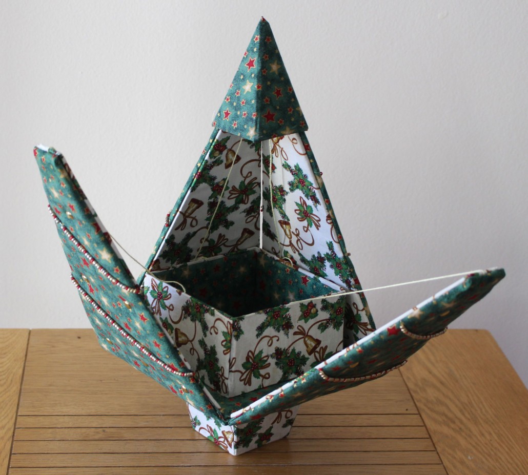 This amazing twist on the usual paper origami is Dee's Fabrigami.  These unusual fabric covered boxes are great fun!