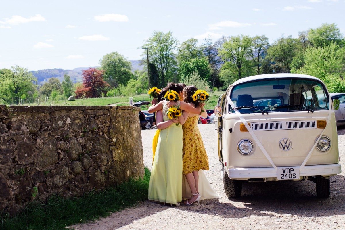 Comrie Croft yellow bridesmaids hugging