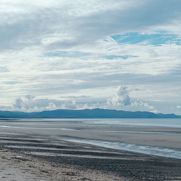Beautiful beach with bright blue cloudy sky.