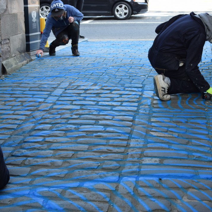 Vennels Guerilla Art Project Water Vennel painting the cobbles blue!