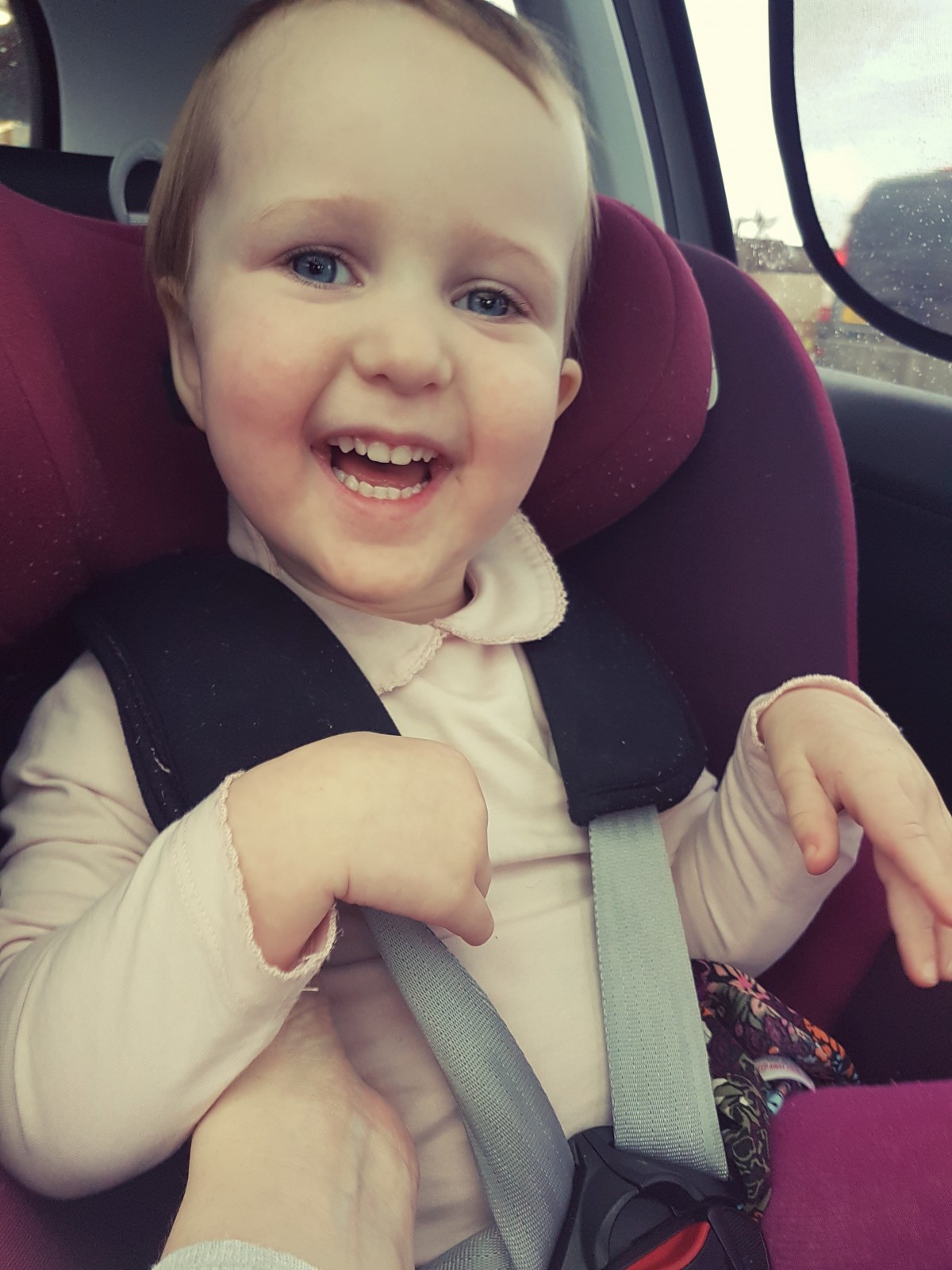 Freya smiles in car