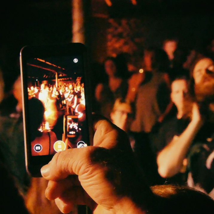 Man filming the crowd at Hunter and the bear on his phone.