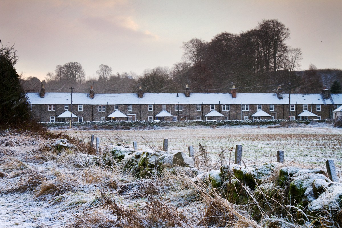 The first frost sets over a row of farmers cottages