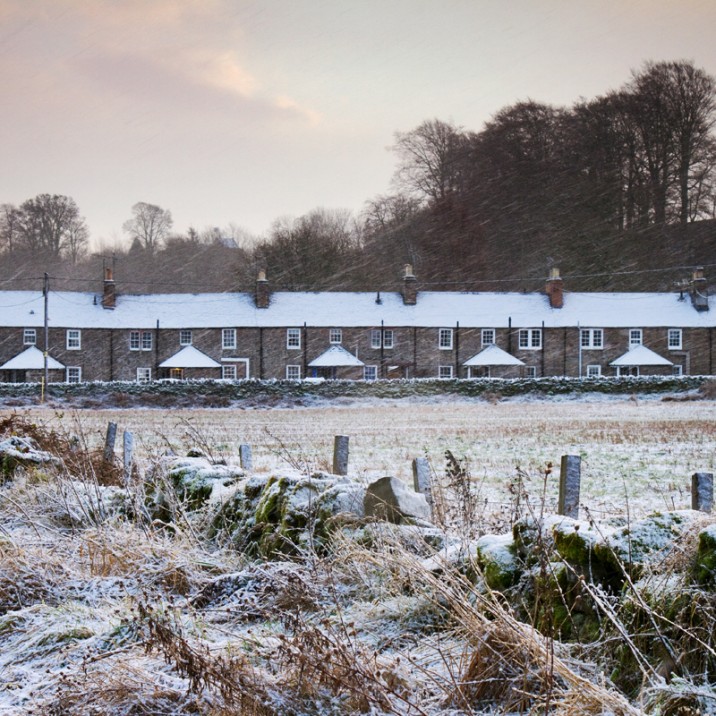 The first frost sets over a row of farmers cottages