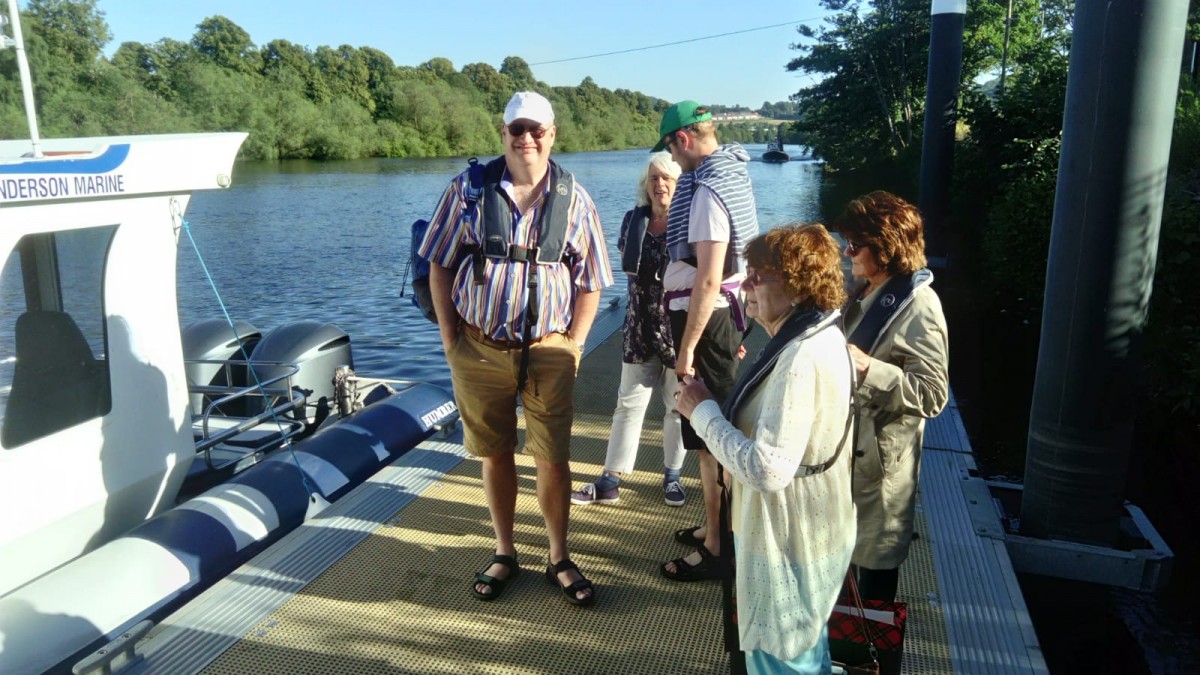 Explorers stand eager waiting to board the boat on the River Tay