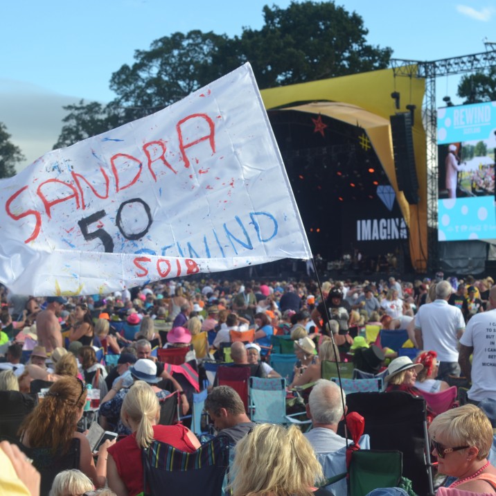 Crowd picture with 'Sandra's 50th' flag - Rewind 2018