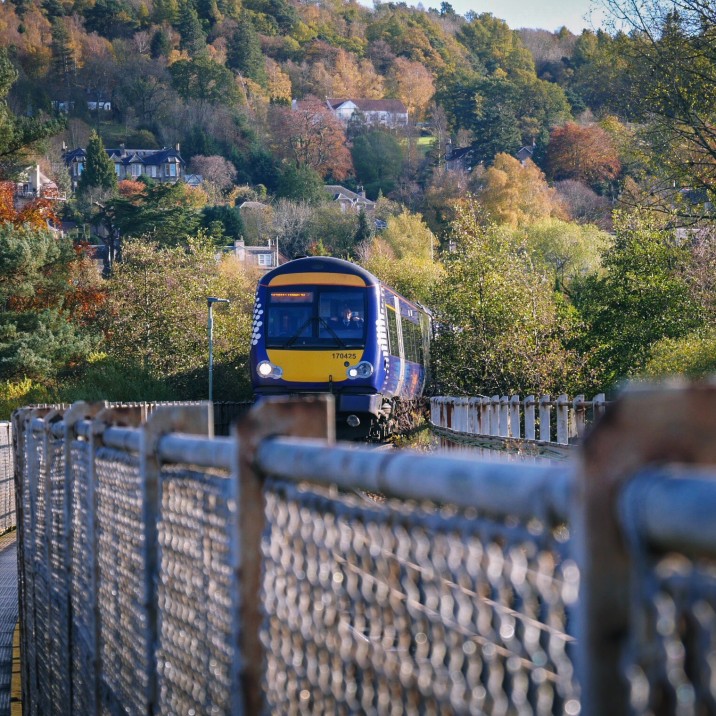 Walkway close to track, leading to Moncreiffe Island and the east bank river path. Smile at the driver!