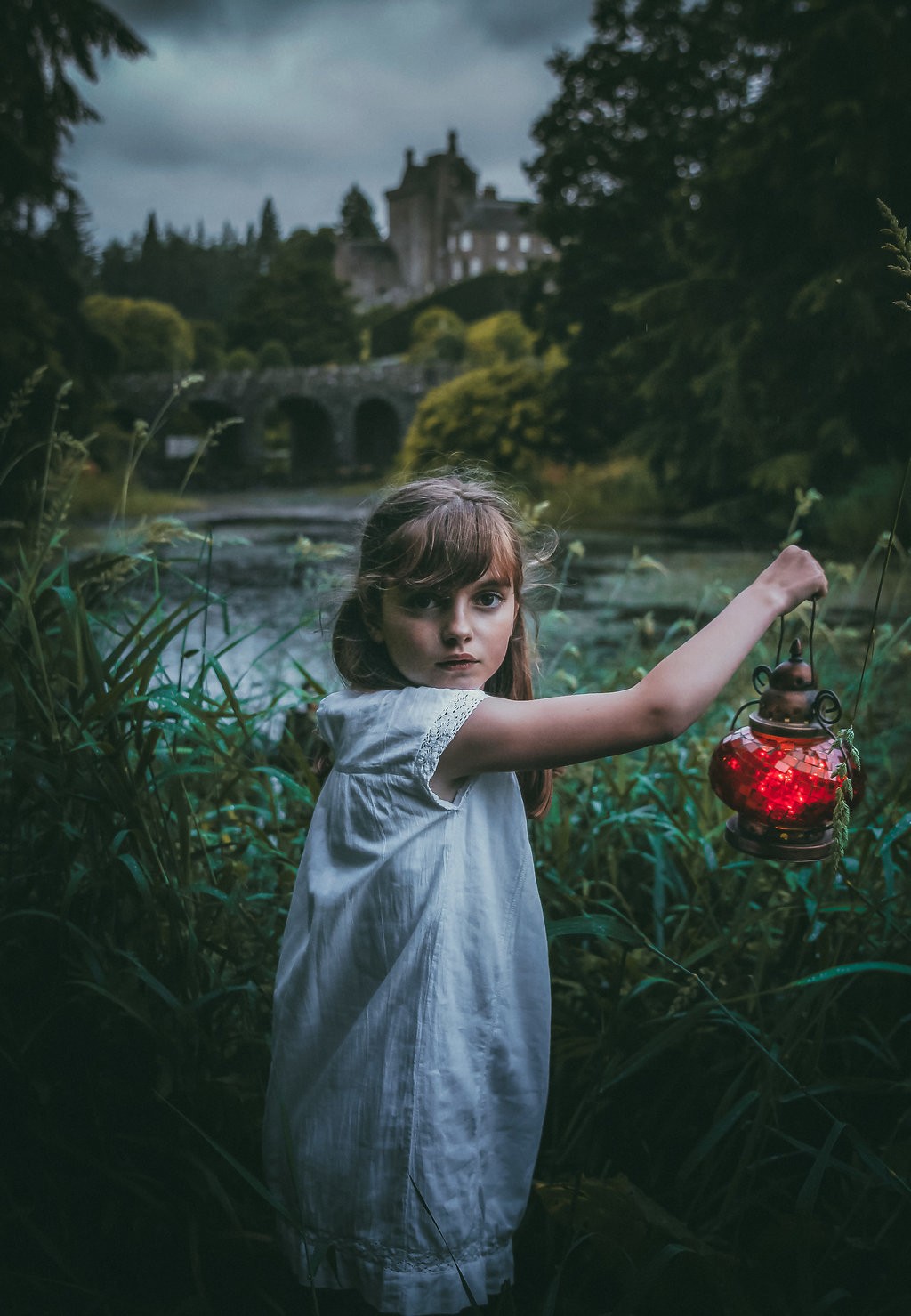 A young girl with an enchanted look in her eyes on the grounds of Drummond Castle in Perthshire.
