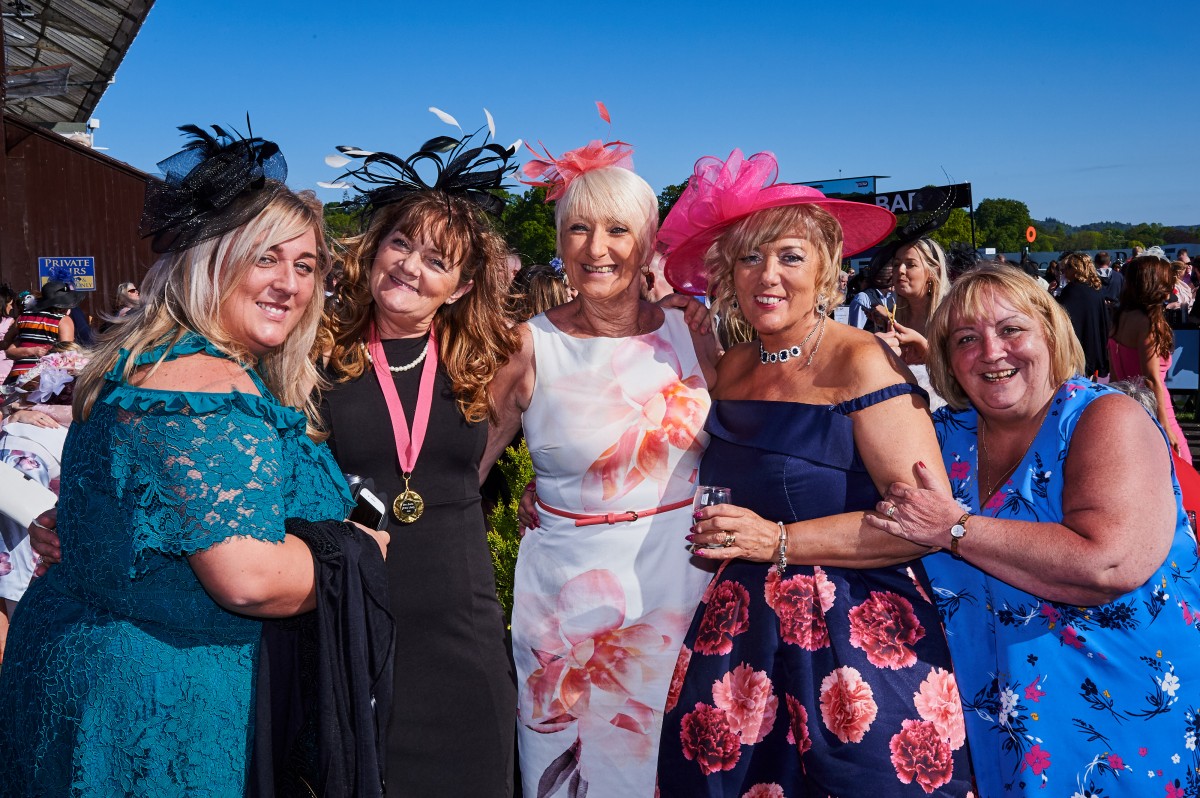 A group of friends with one sporting a nomination medal for Grand Lady!