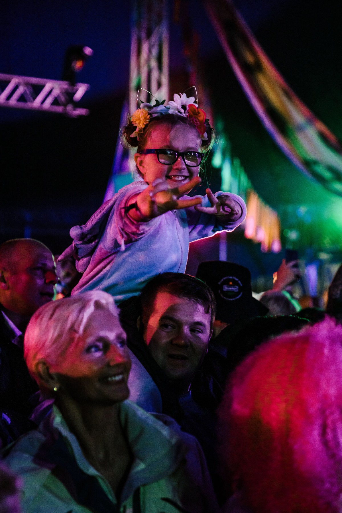 A young fan gets a kiddy back to see over the crowds at Rewind 2019.