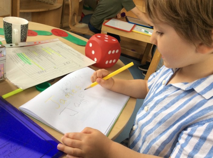 James learns how to hold a pencil