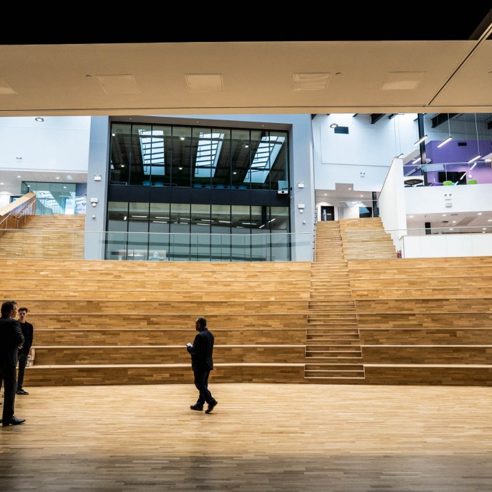 The pale wood cascade seating of the auditorium, coupled with breathtaking natural light, gives the room an incredible feeling of space.