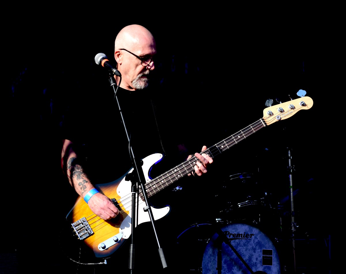 Rab Dobbie of The Foosties enjoying a moment on stage in the sunshine.