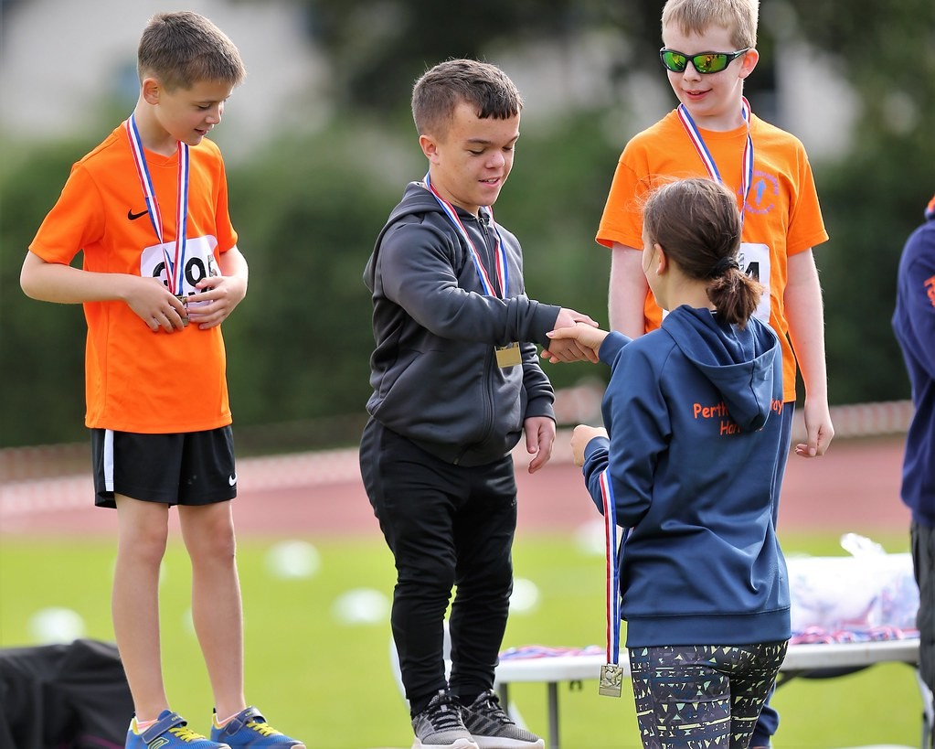 The Harriers Athlete Rep, Lauryn Wood, presenting medals to the next generation of young stars.