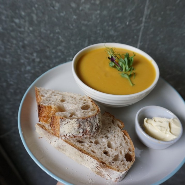 Butternut squash, coconut and ginger soup with sourdough bread by Wild Heart Bakery.