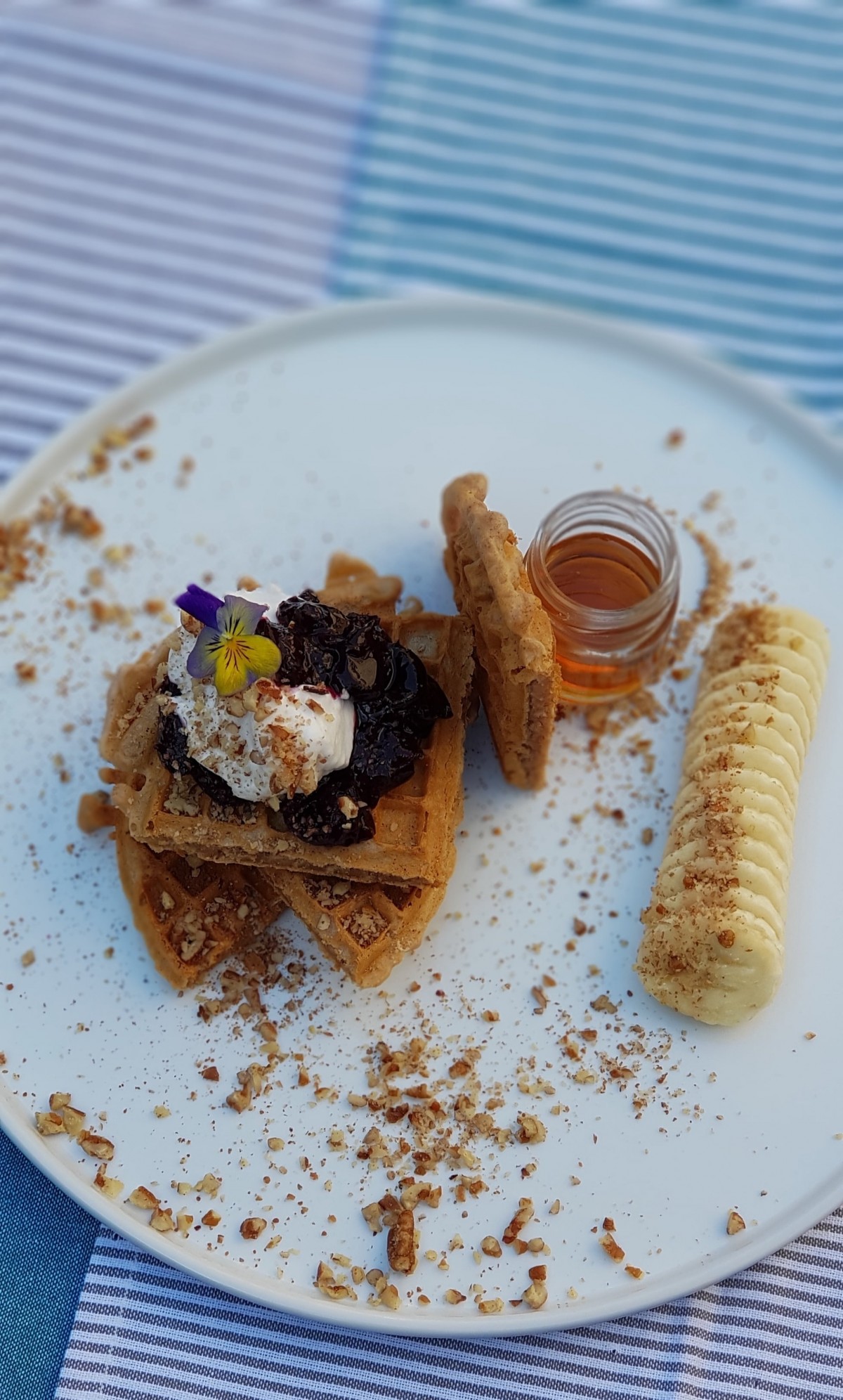 Cinnamon waffle with homemade cherry compote, banana, pecans, coconut yoghurt and maple syrup.