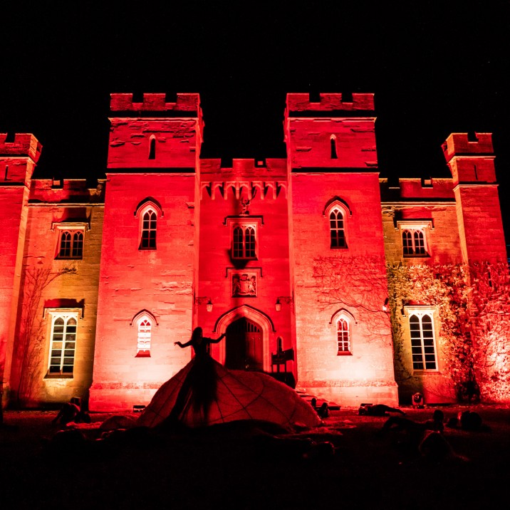 The Haunted Lady creeps past a stunning Scone Palace swathed in demon red.