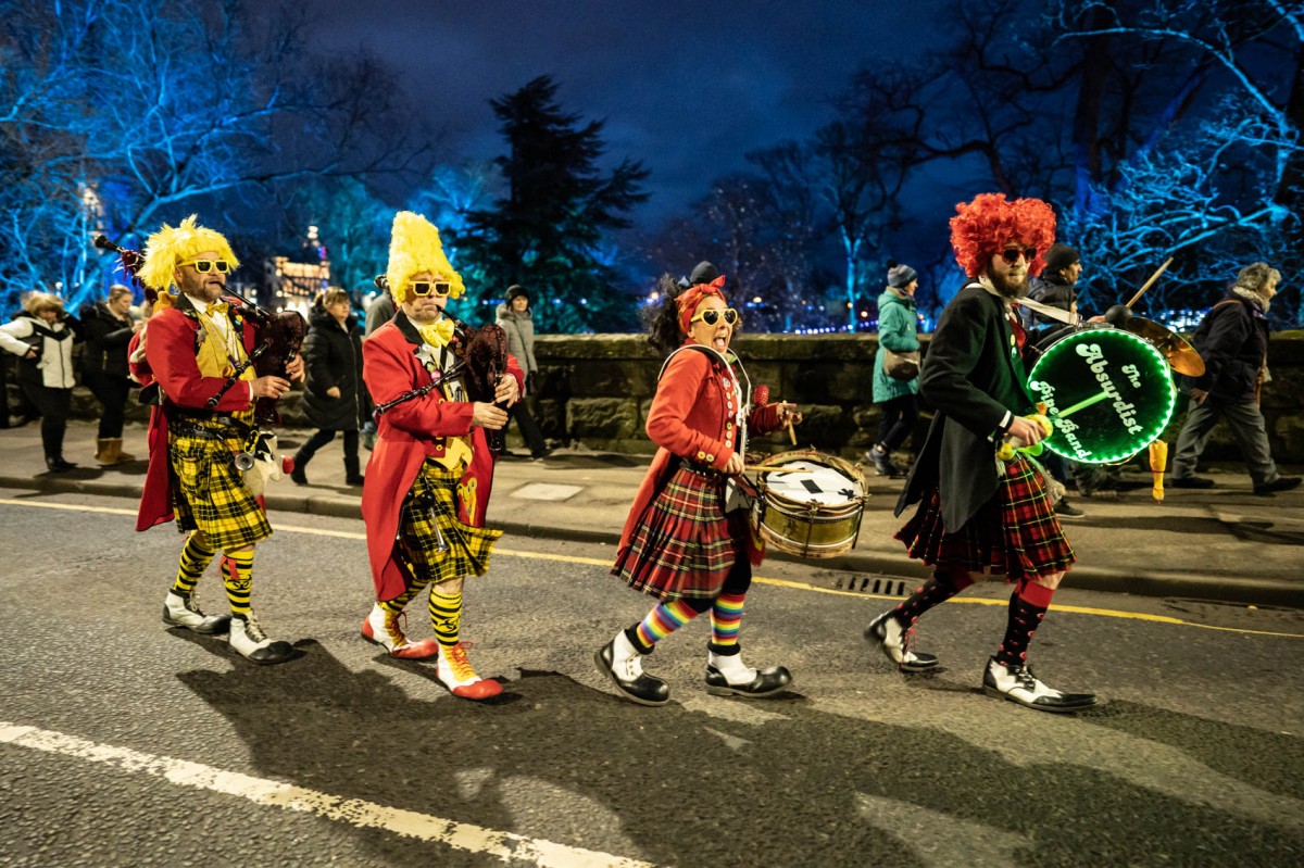 The Absurdist Pipe Band dancing through Tay Street.